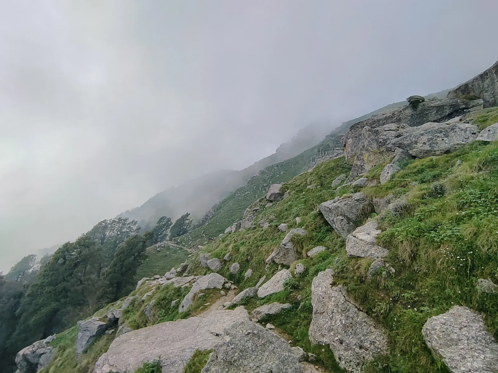 Rocky slope disappearing into fog